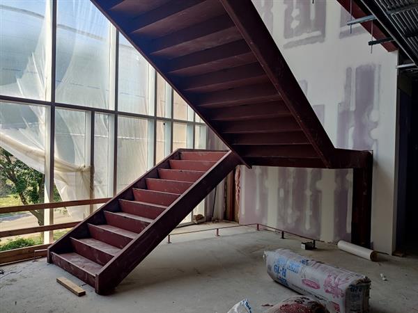 Prepping new stairs to connect the addition with the existing four-story building 